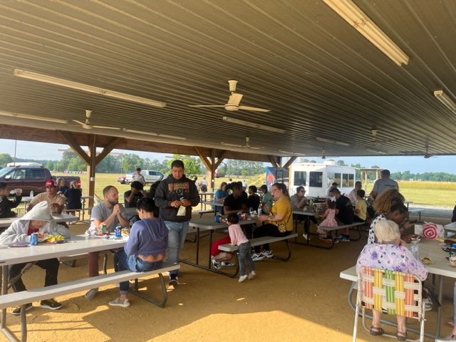 crowd eating dinner under shelter.jpg