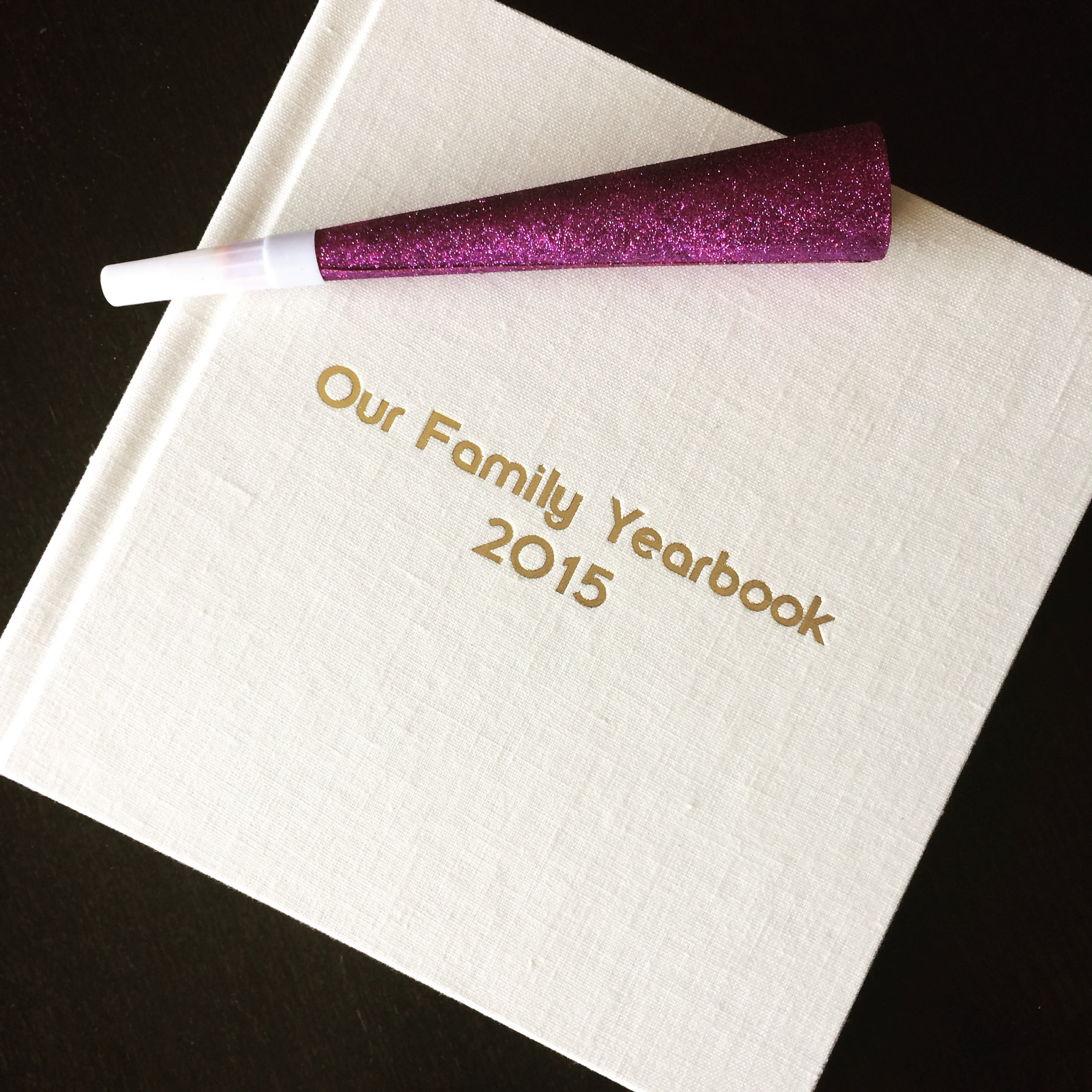 Capture your family's year in a stunning keepsake. | 10" x 10" Signature Album. Linen cover in "tusk" with gold debossed lettering.