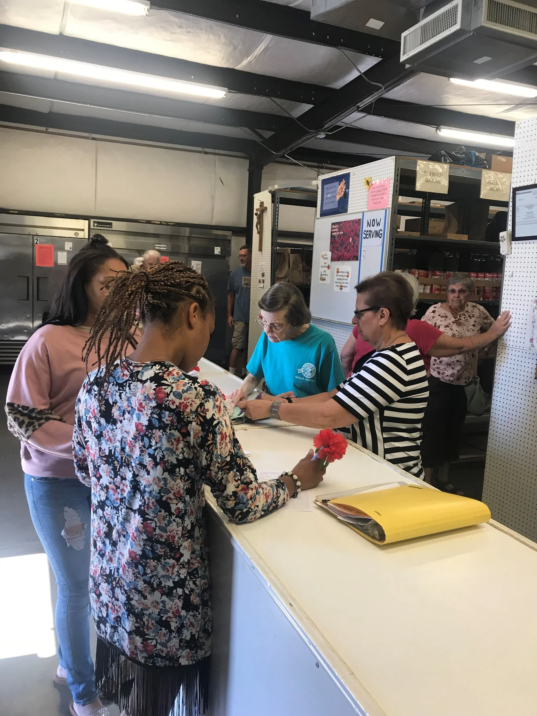 Volunteers greet clients, gather basic information and start shopping.