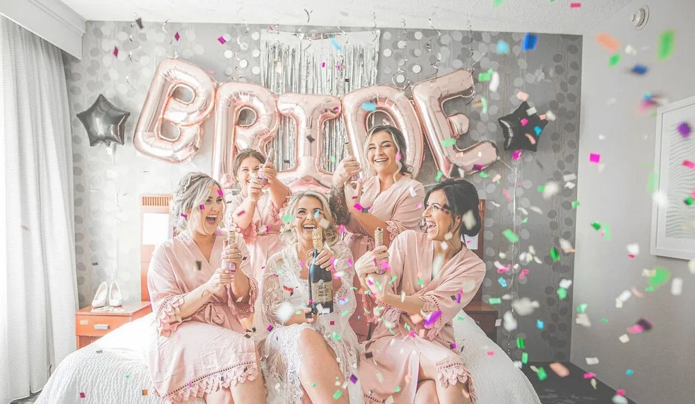 Bride with champagne during prep