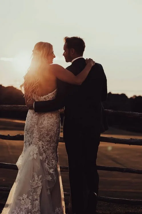 Sunset wedding photograph of a couple looking at each other by the wooden fence at Skyview Golf Club in Sparta, NJ 