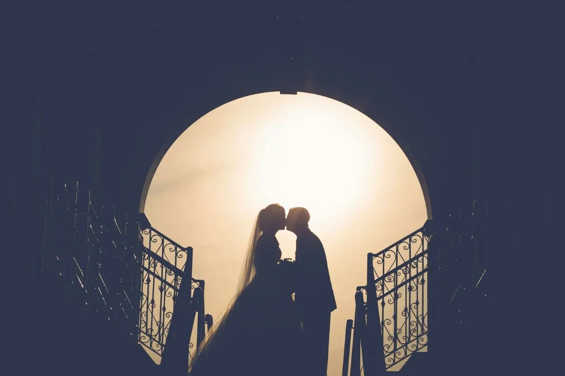 a Silouette wedding photograph of a bride & groom kissing on the staircase at Trump National Bedminster NJ 