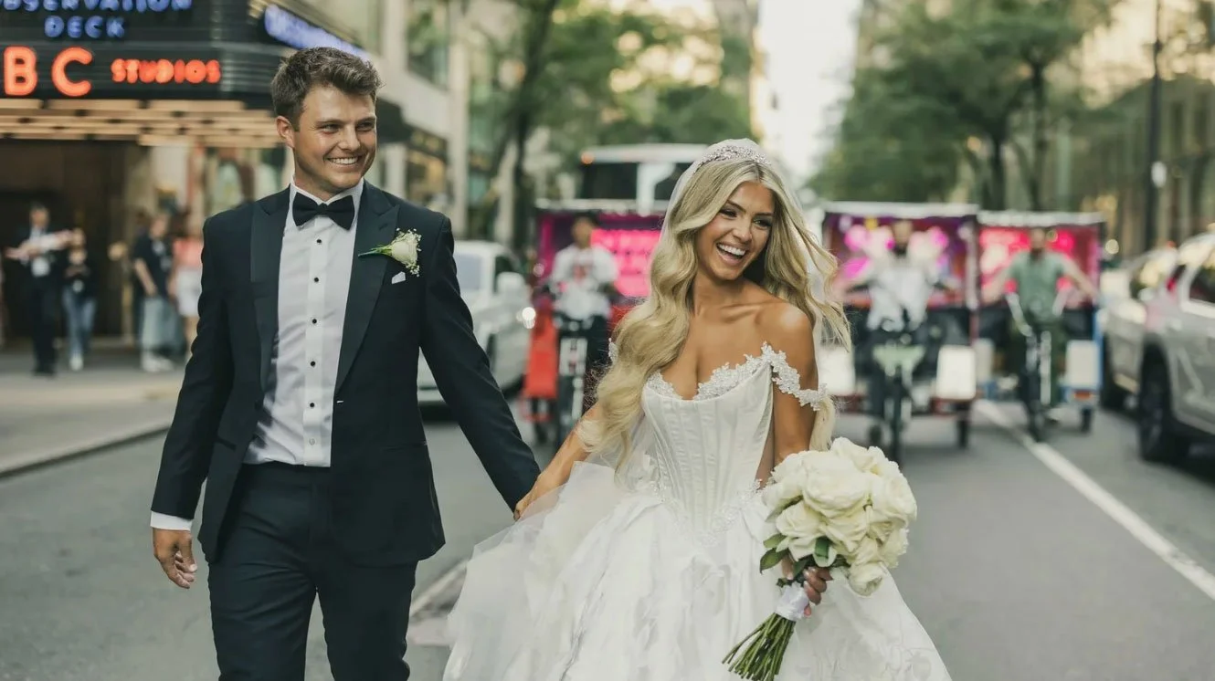 Zach Wilson NFL Quarterback Wedding Photos outside The Rainbow Room in NYC running with his new bride. 