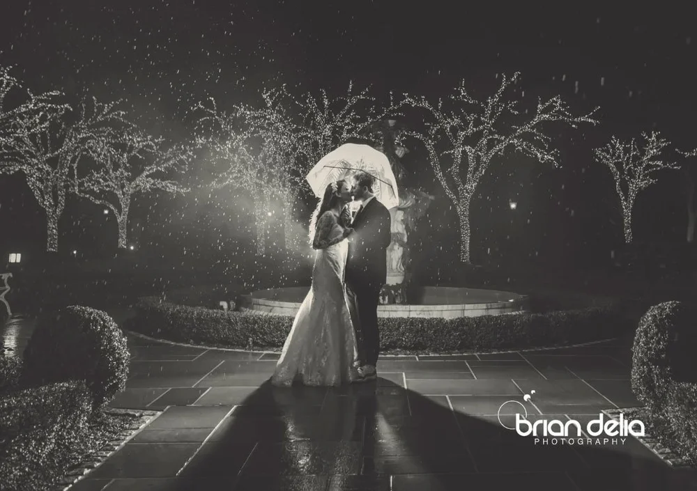 Bride and groom kissing in the rain at night, Park Chateau
