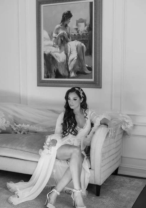 Editorial Style Wedding Photographer captured a New Jersey Bride sitting on fancy chase in the bridal suite at Nanina's in the Park, Belleville, NJ 