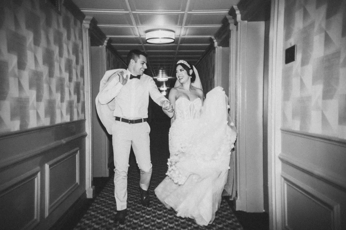 Bride & Groom running down the hallway at The Madison Hotel in Morristown, NJ wedding photo captured on 35mm film