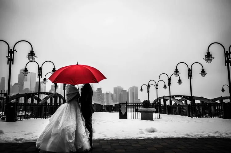 Couple with red umbrella on the dock at Liberty House, Jersey City