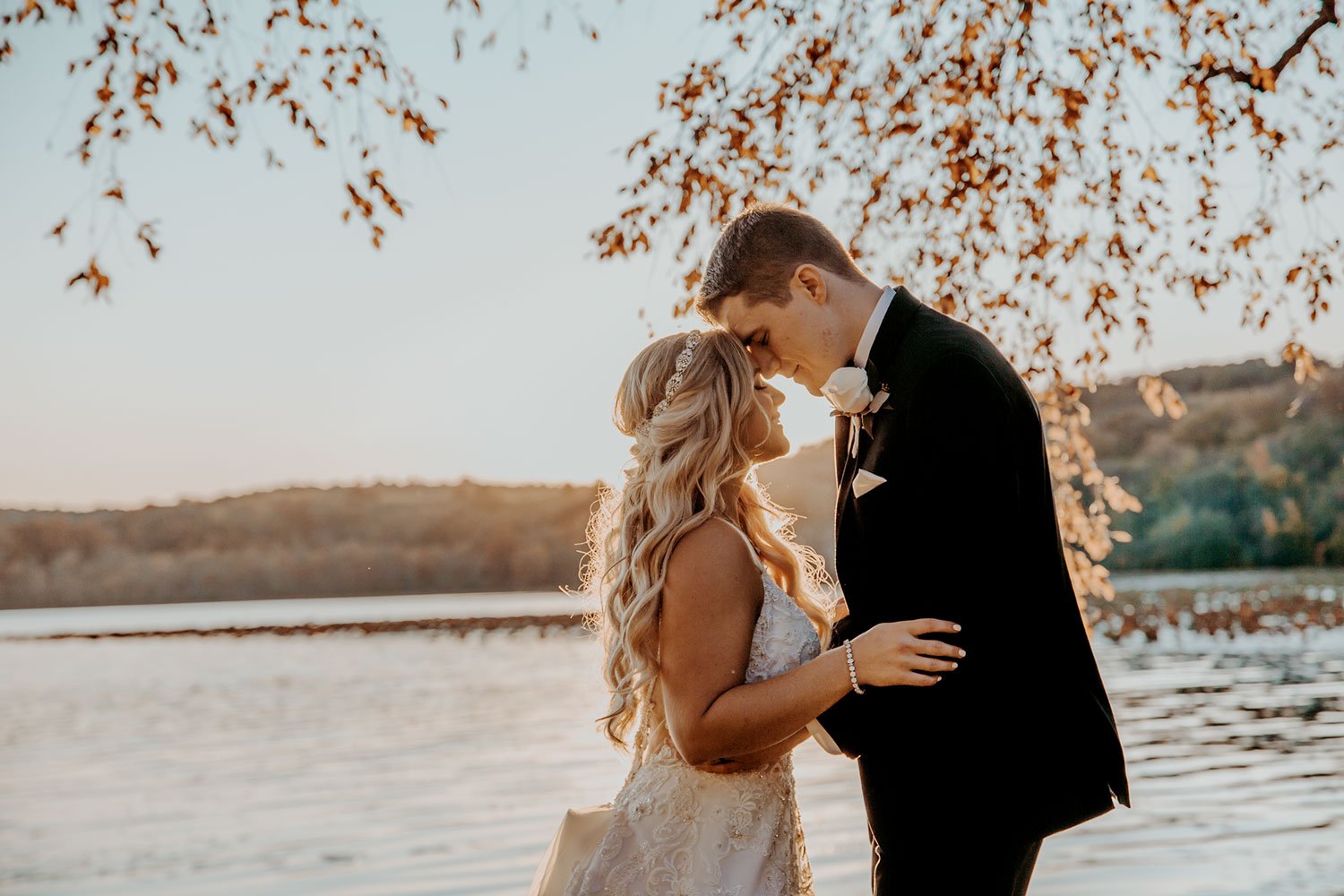 Bride and groom embracing at golden-hour sunset, light and airy New Jersey wedding