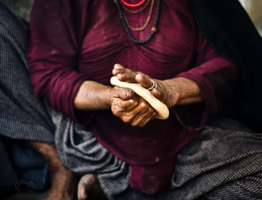 Tribal woman making bread in Western India. Photo by Harry Thaker .