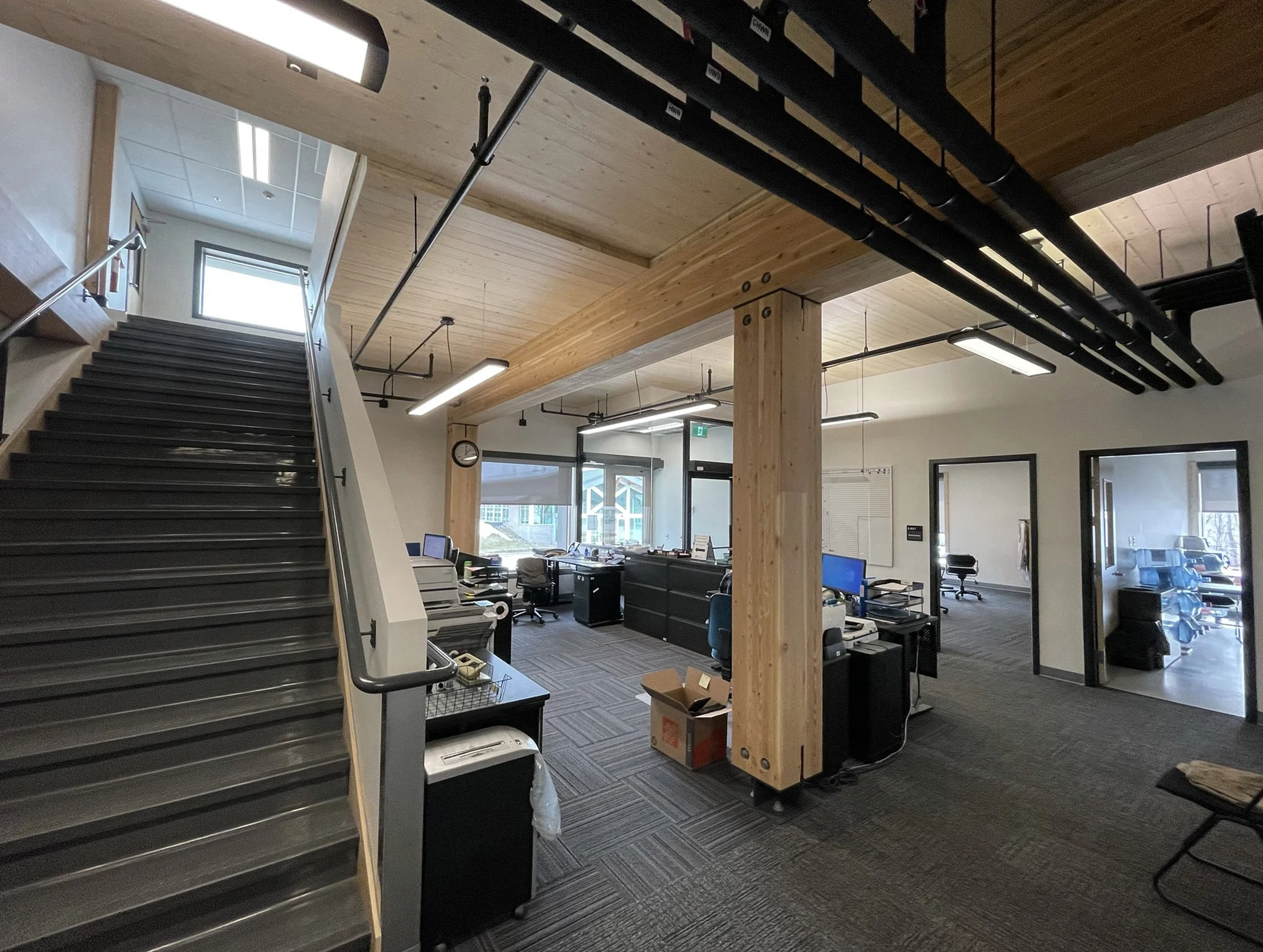  Level 1 Interior with exposed CLT ceiling and exposed edges at stair opening.   