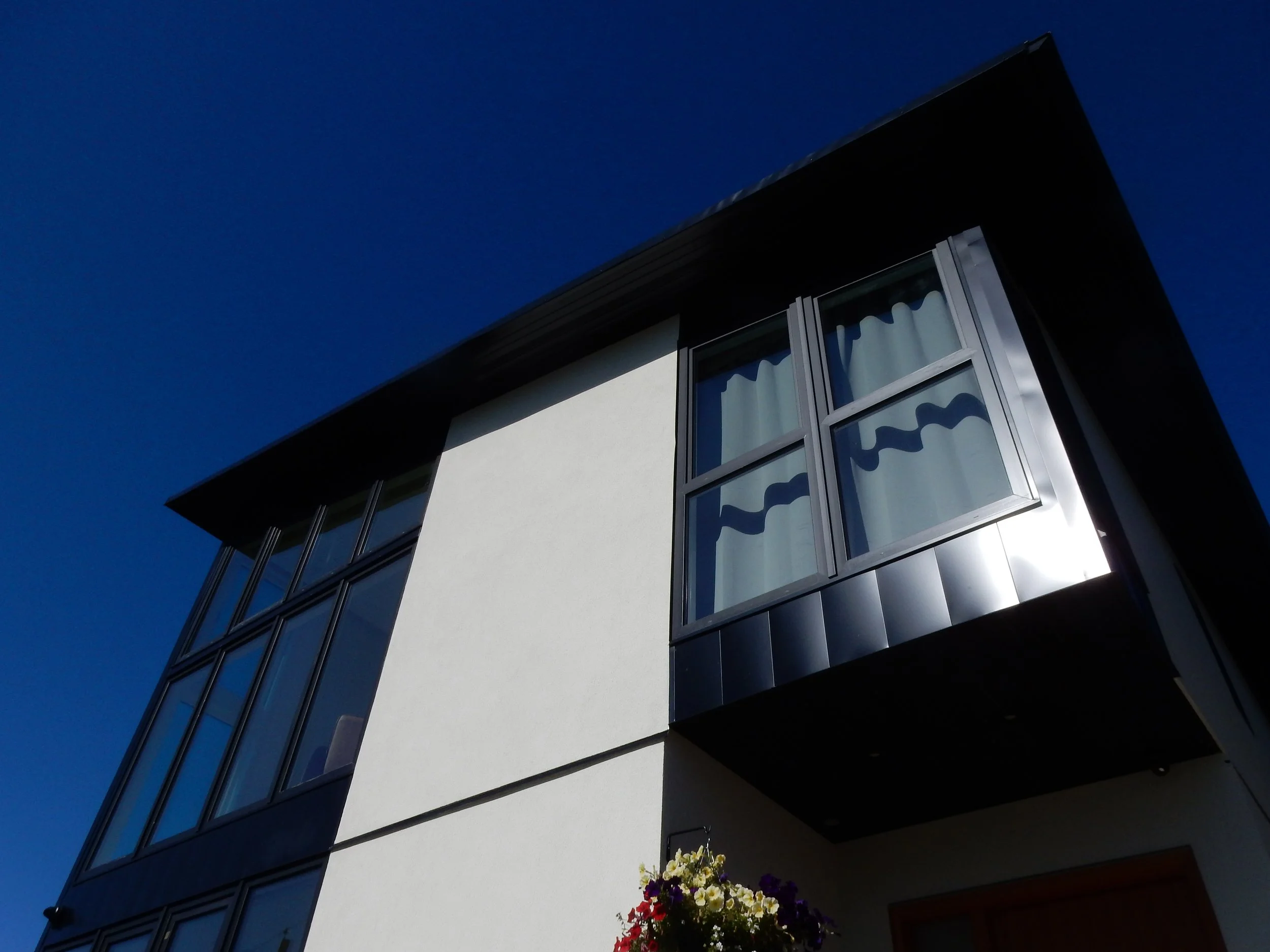  Front façade window wall facing eastward views.    