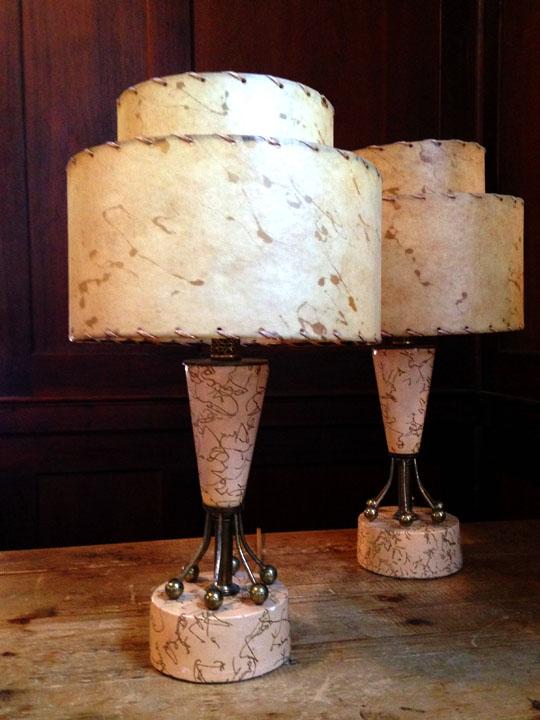 Pair of Vintage Atomic-Style Mid-Century Modern Accent Table Lamps Pale pink bases with brass hardware, neutral-color fiberglass shades. 18"high with 10"diameter. Electrical connections needs work (one turns on with a bit of play—the other does not). $150 for the pair