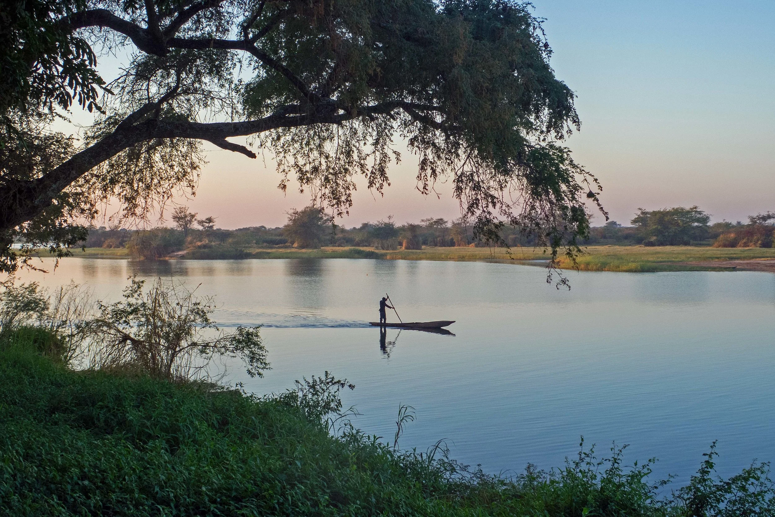 A Mwandi fisherman heads out at sunrise.