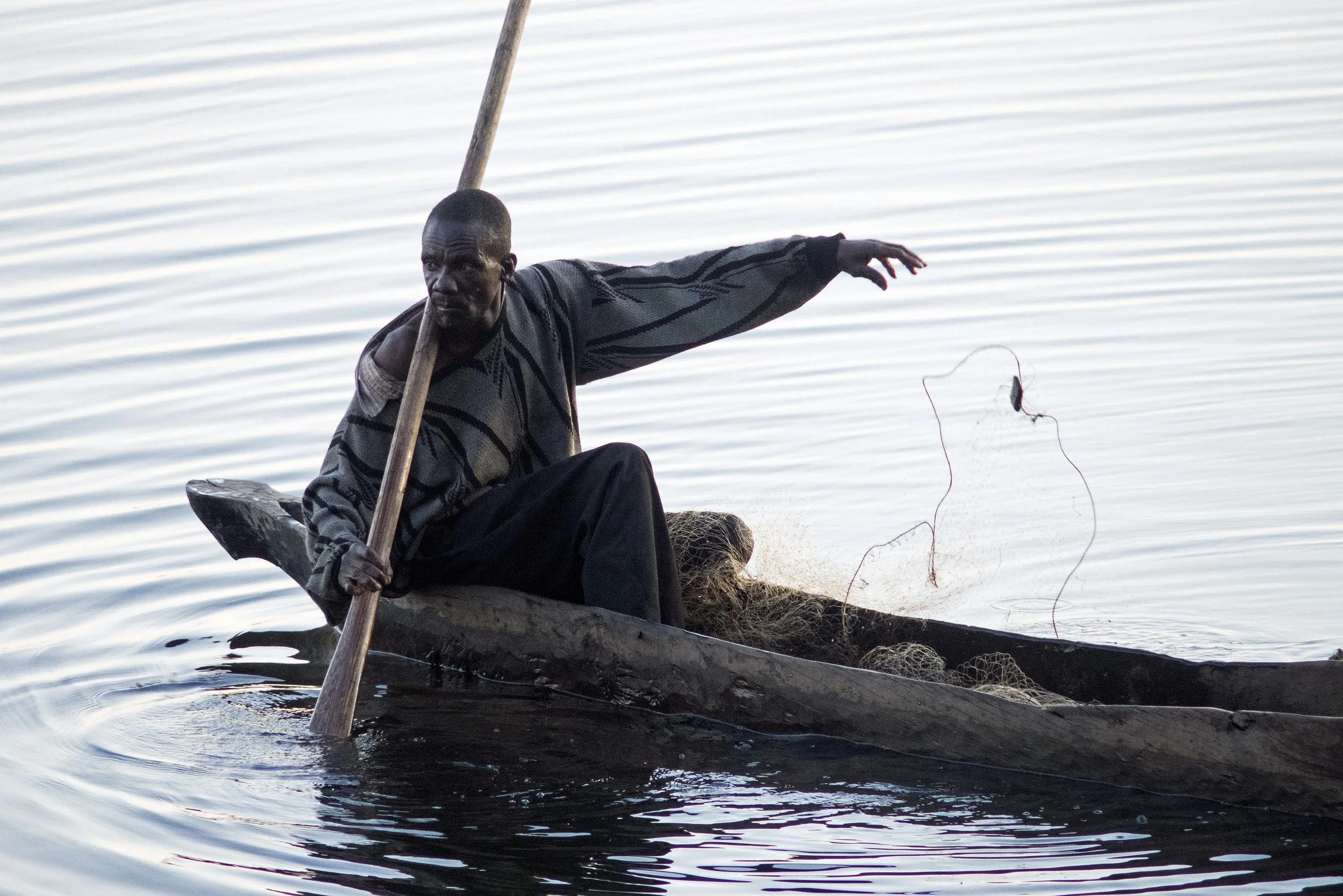 A Mwandi fisherman checks his net.