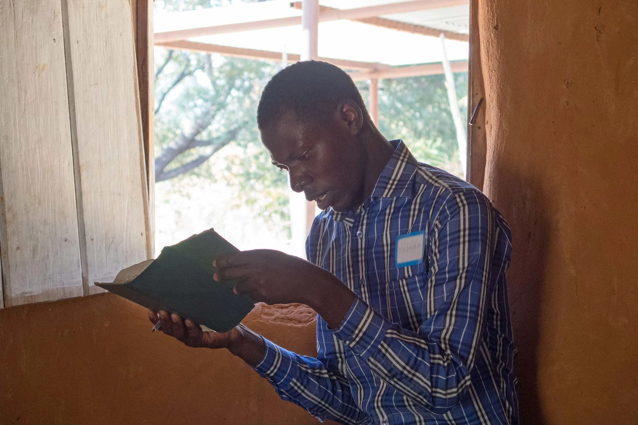 Mushiba, a brilliant and friendly young student, reads Scripture from the Lozi Bible.
