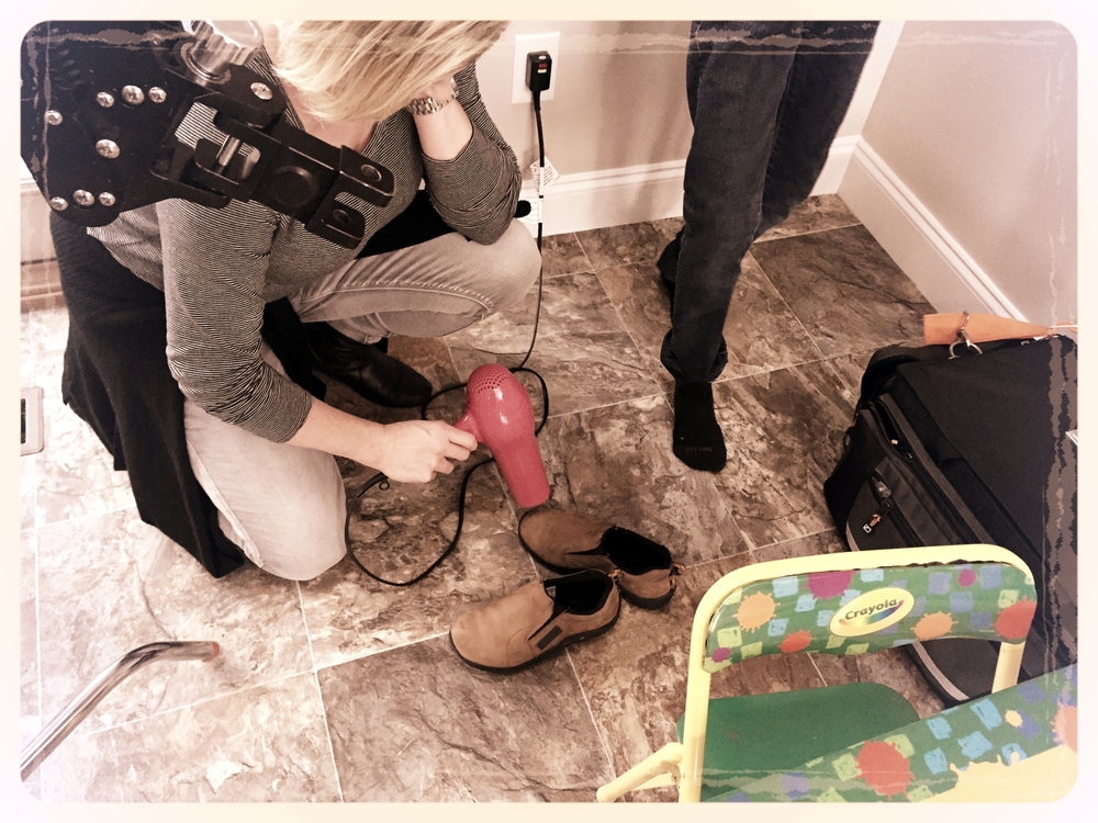 6 STRONG MEDIA Makeup Artist (Angela Jordan) quickly dries our actor's shoes so we can get a few more takes of the dog food scene.
