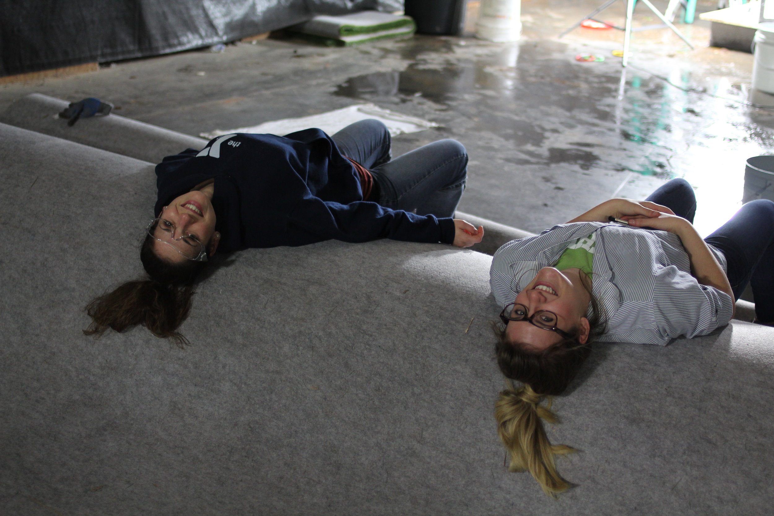 Clients taking a little break on a big roll of carpet.
