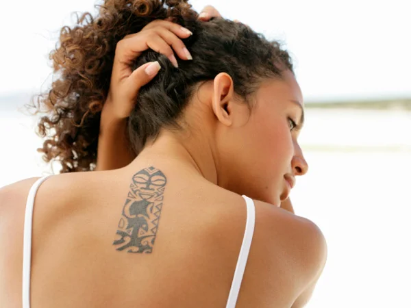 woman with back tattoo