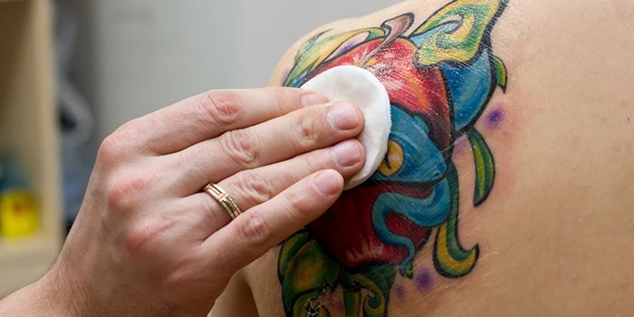 applying ointment on a tattoo