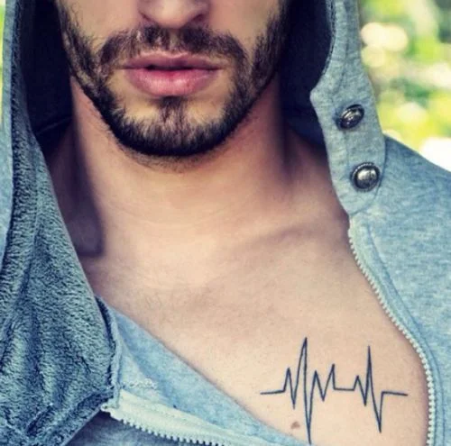 man with a small chest tattoo
