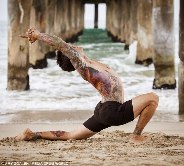 yoga man with tattoo