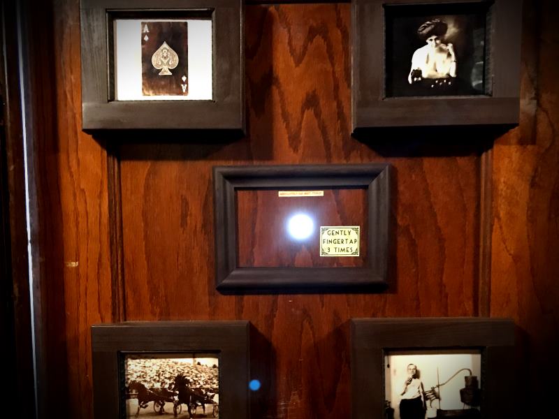 A door with a peephole and interesting period photographs is intriguing...