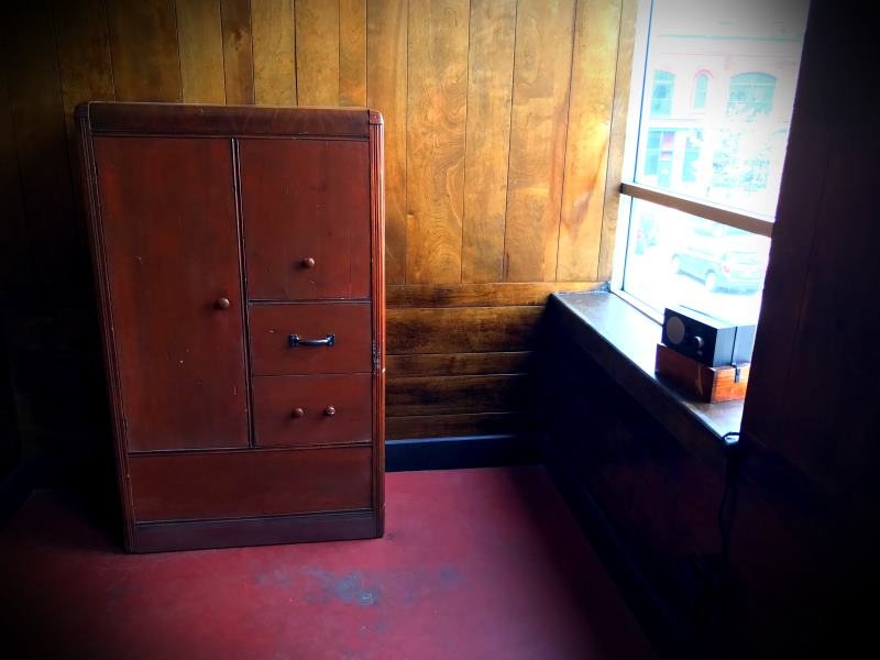 ...an old dresser and Crosley radio can be seen.