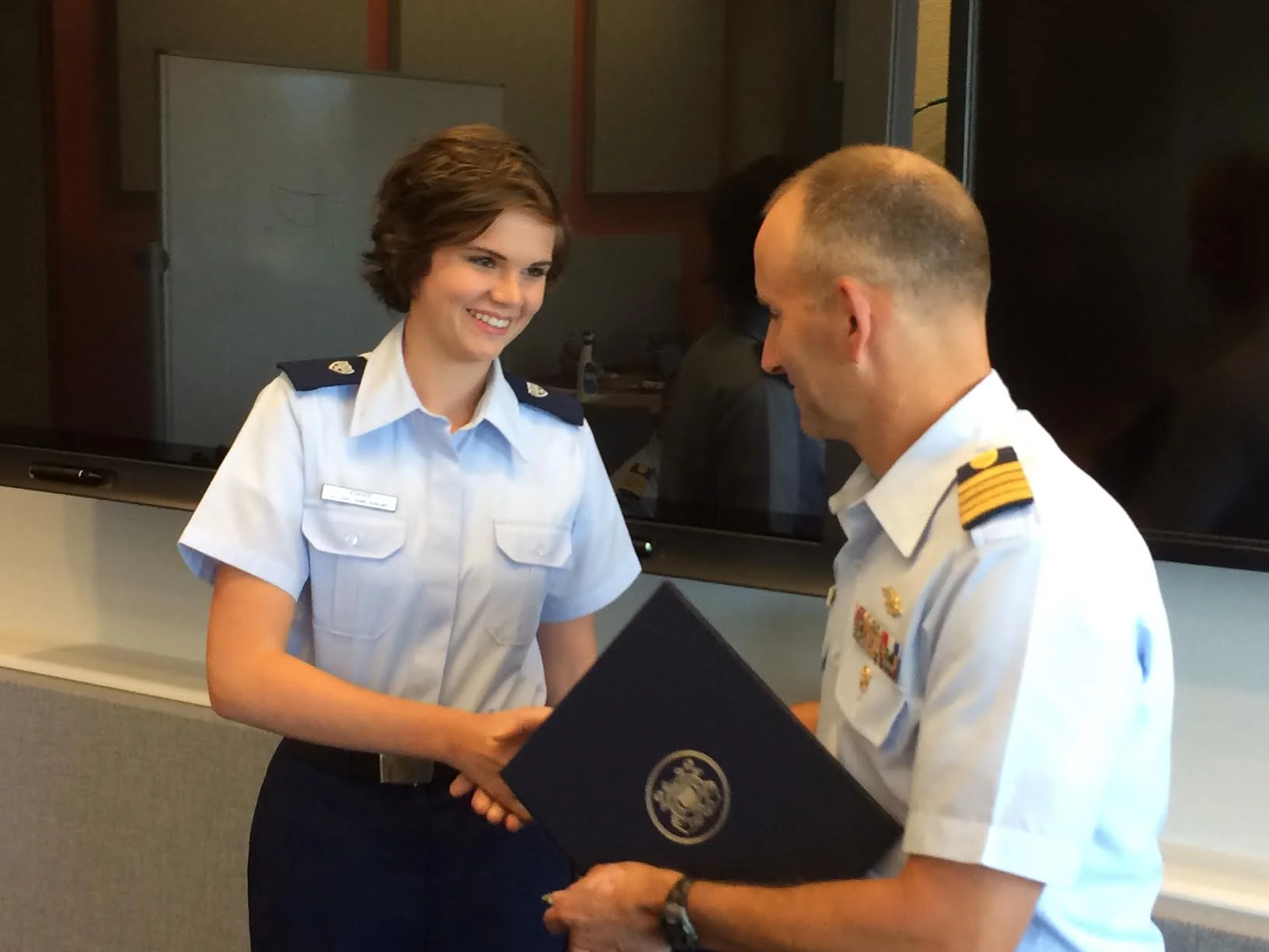AUP's Caroline Howard, who is the deputy unit leader for Unit William and Mary, is presented with a commendation for her service during her summer internship at Coast Guard Headquarters. (Photo courtesy of Lt. Commander Molly Waters)