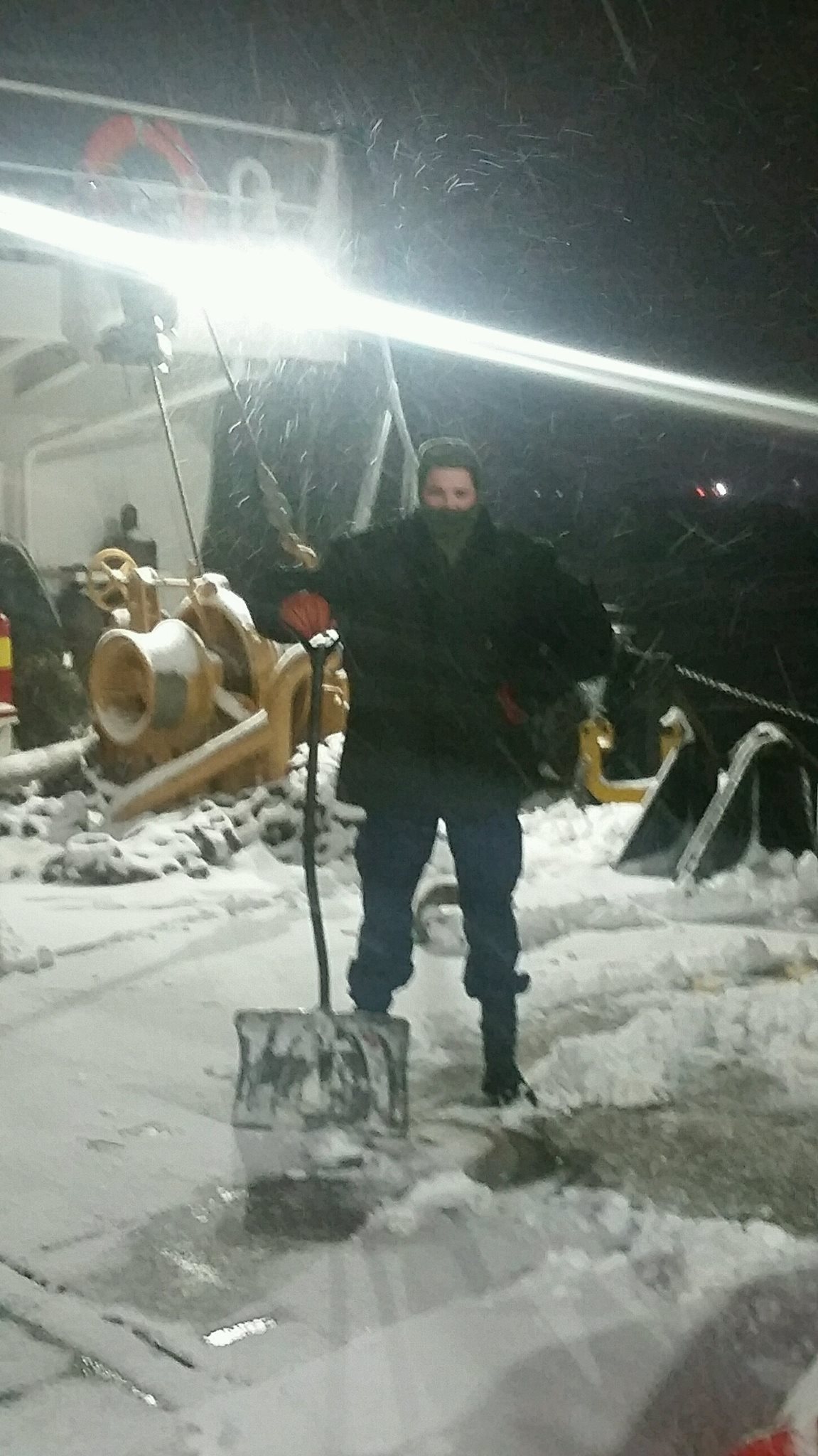Auxiliarist Howard shoveling snow off the buoy deck.