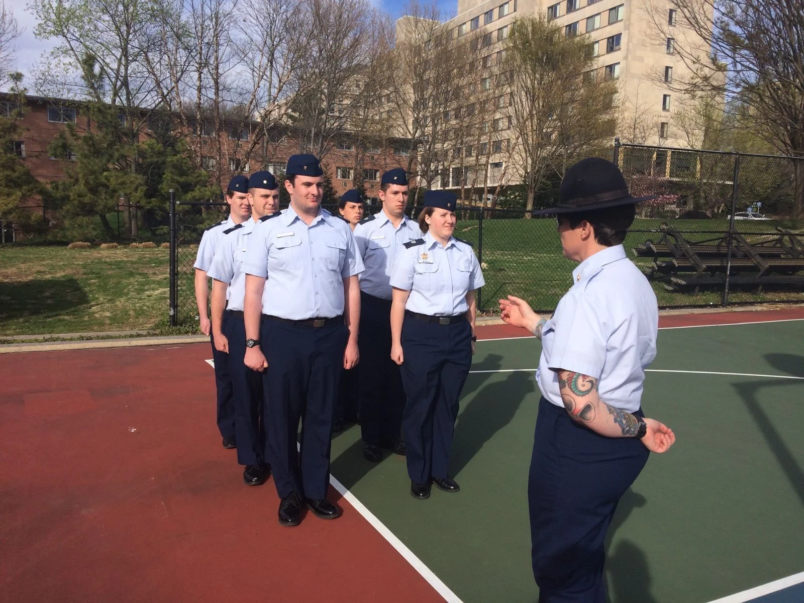 Members of the United States Coast Guard Auxiliary University Program receive drill from Company Commander MKC Reid at American University.