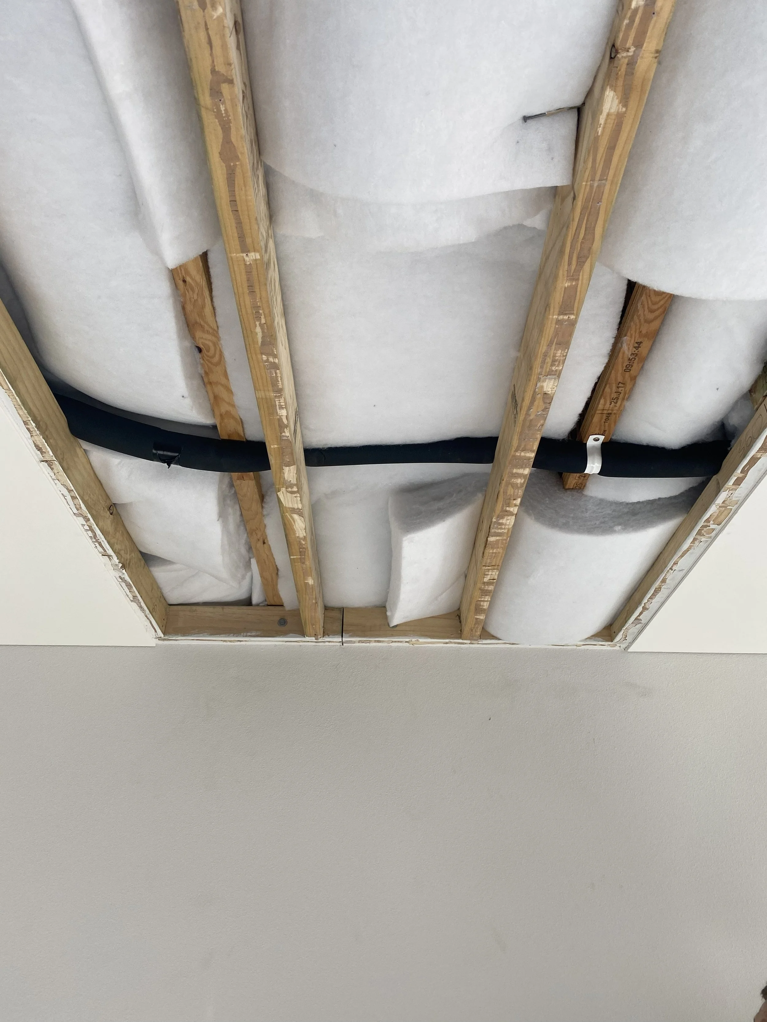 An insulated ring main pipe running through the ceiling. 