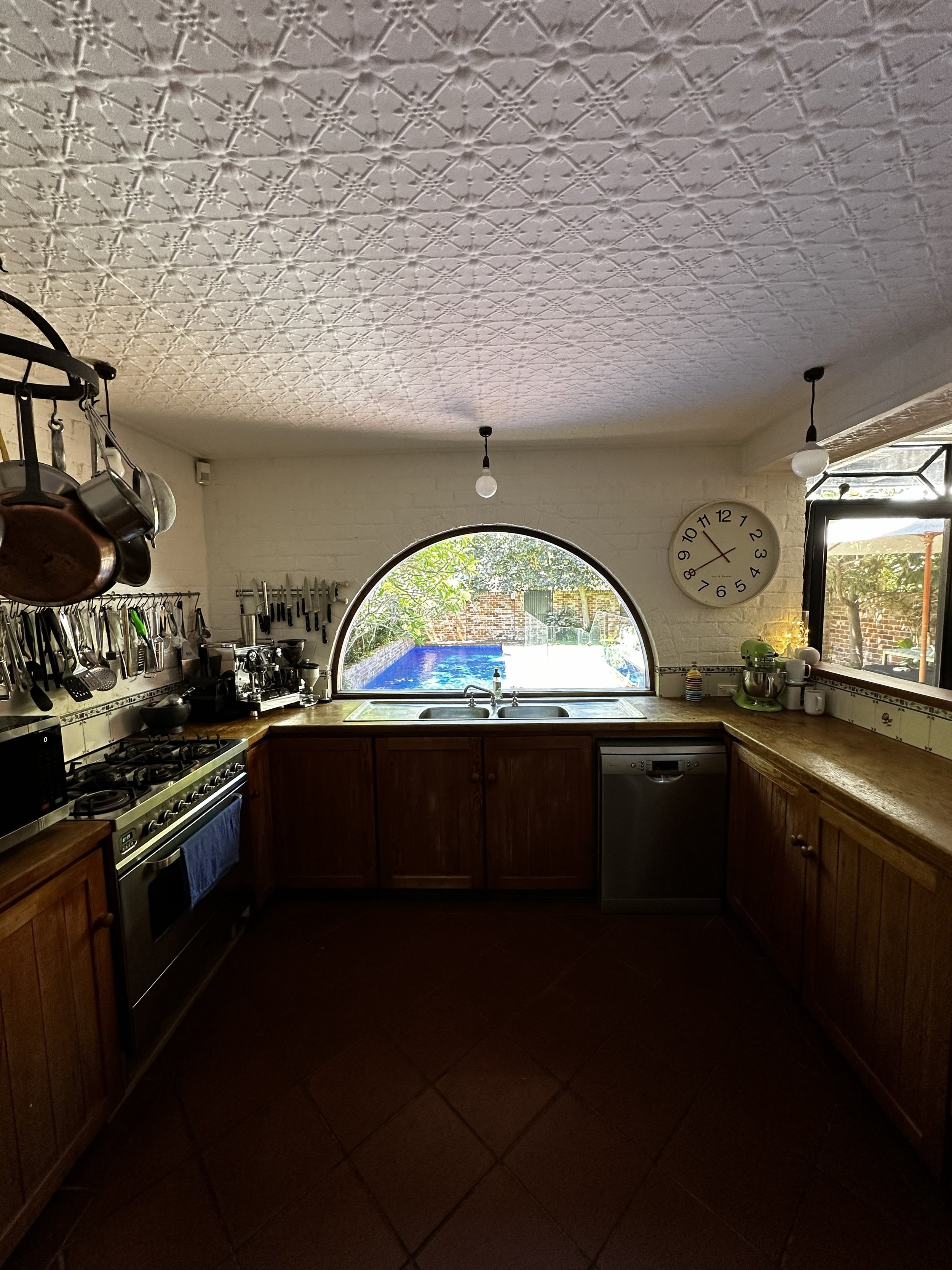 And a very unique kitchen with a curved window and pressed tin ceiling.