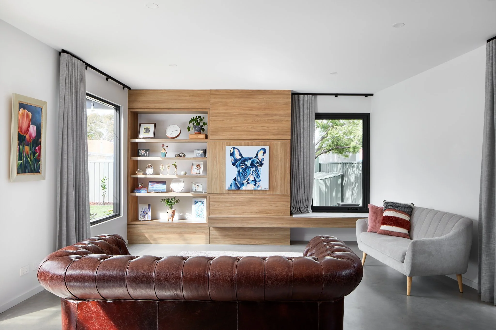 Timber-look custom-built shelving with a concealed TV at one of Arklen's new builds.