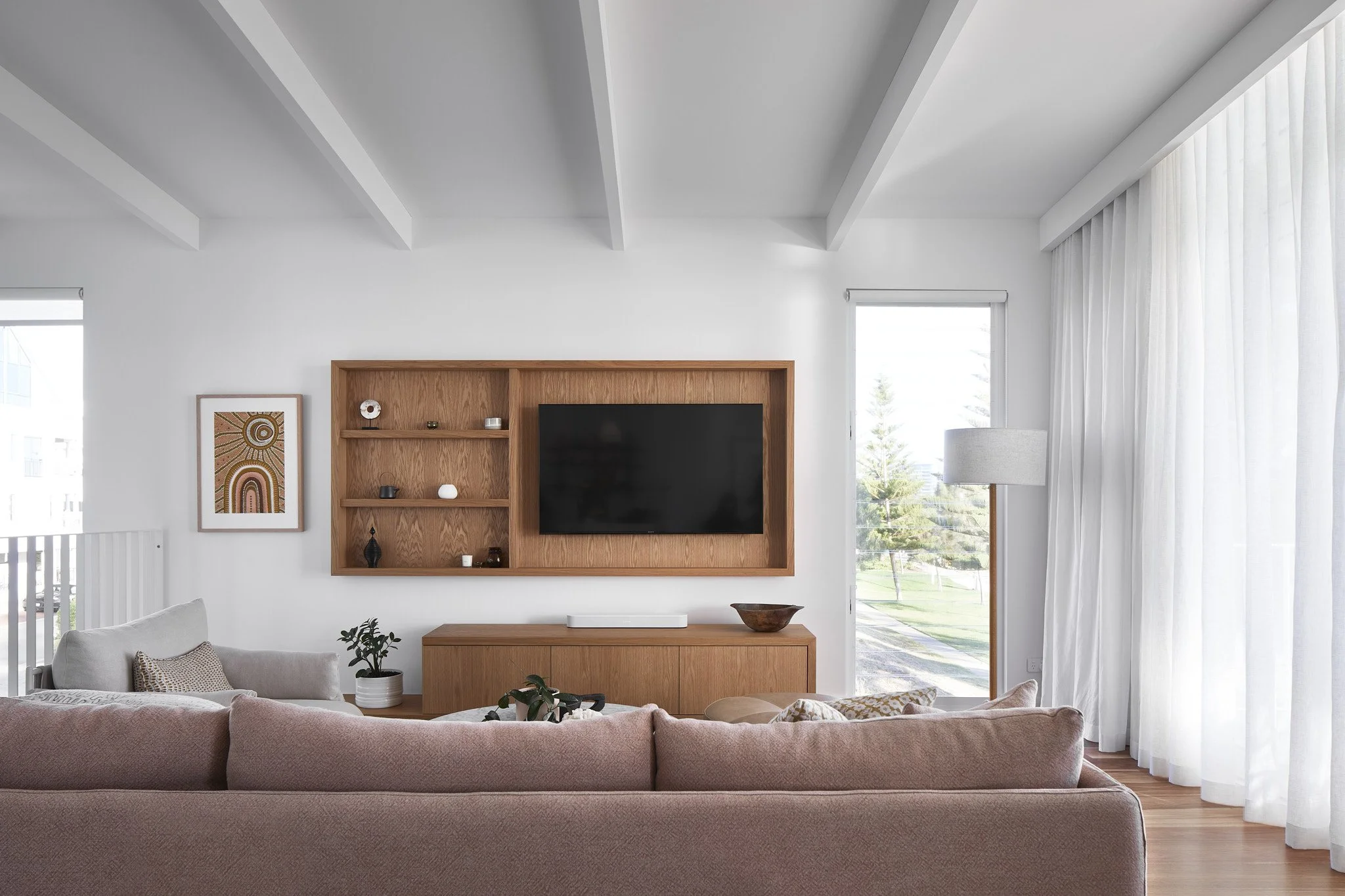 A timber-look custom TV cabinet built into the wall at Arklen's Mandurah project.