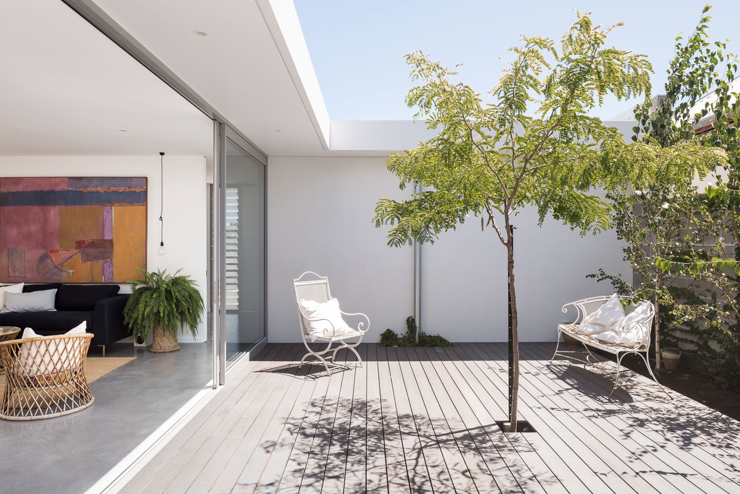 An internal courtyard with timber decking at Arklen's new home build in Beaconsfield.