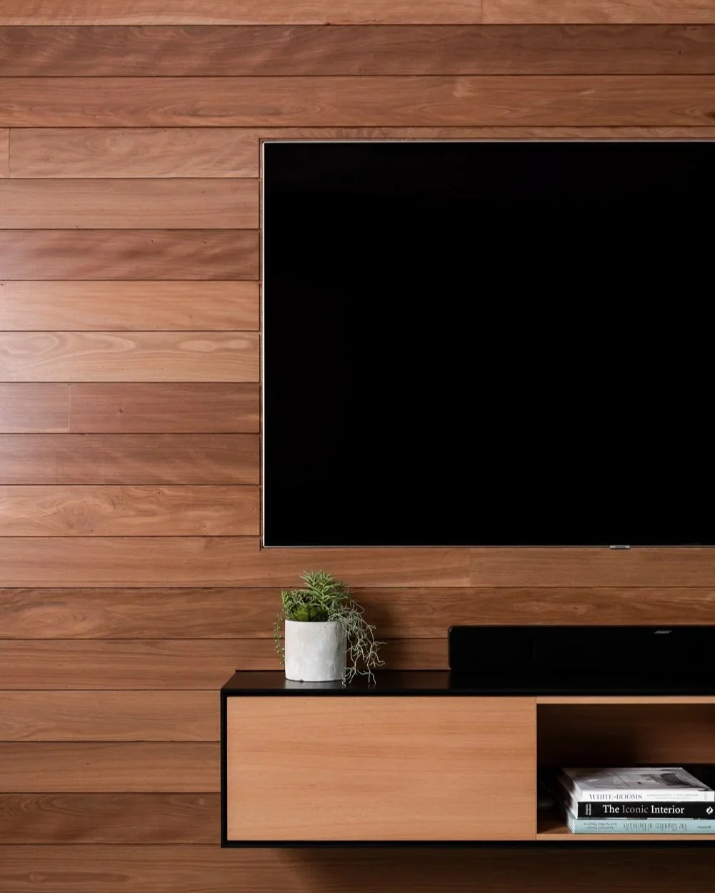 A close up of a TV perfectly fitted into a timber wall at an Arklen new build in Claremont.