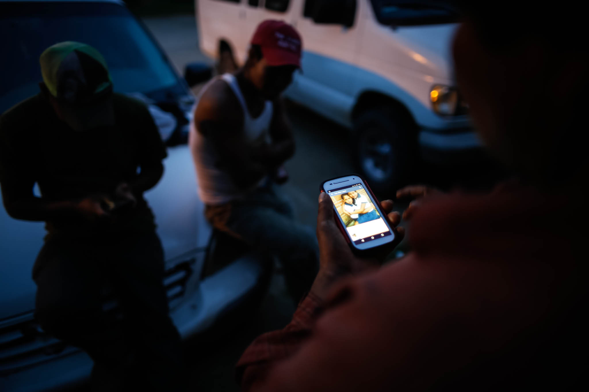 Benjamin Cruz Perez, 42, views a photo of his family in Mexico in front of the apartment he shares with fellow migrant workers. 