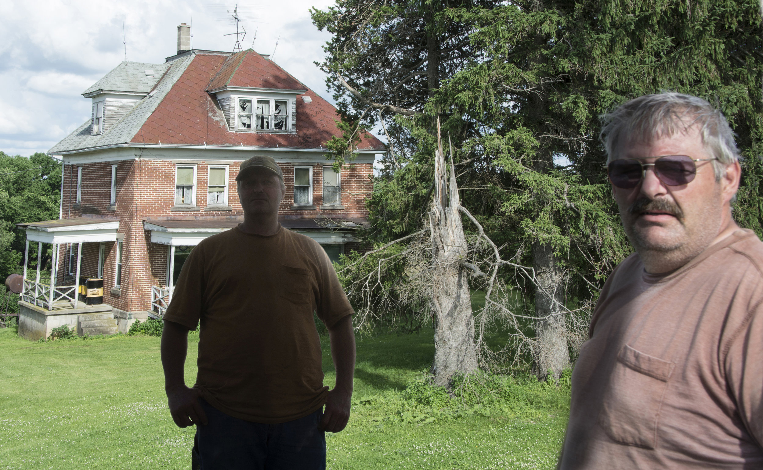 Gary and Harold Alt live together in the old brick house their grandfather built in 1913. They farm 200 acres of corn and have a herd of 26 dairy cattle. They can’t afford to fix up the family home because they spent $6300 per month on their mother’s care in a nursing home until she died.