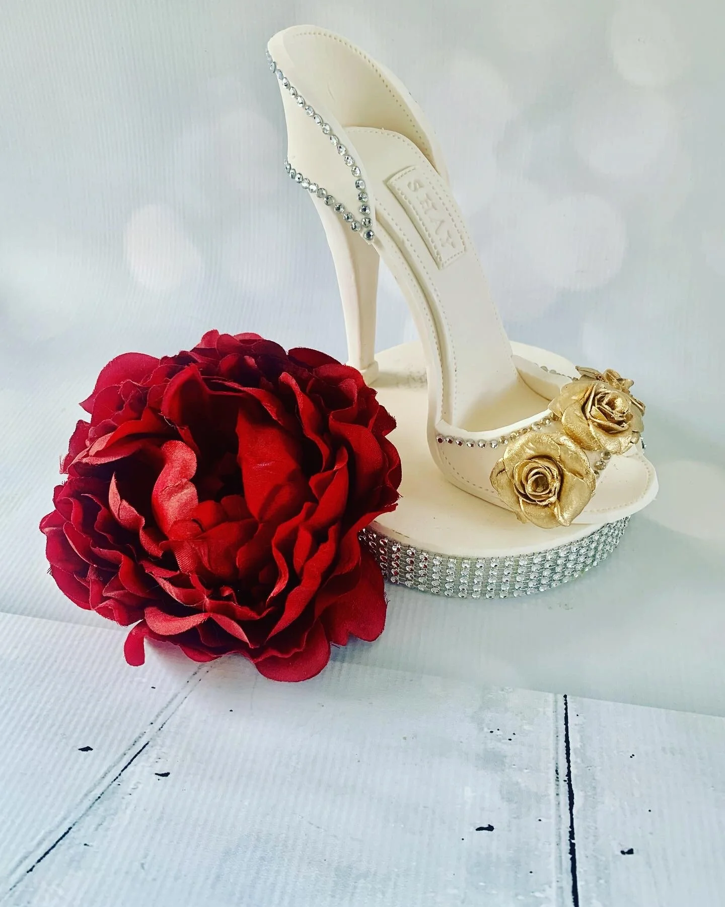 This is a handmade high heel shoe made from gumpaste and non-edible rhinestones to be used as a cake topper. Good for any Birthday, Bridal and Wedding Custom Cakes at any Celebration