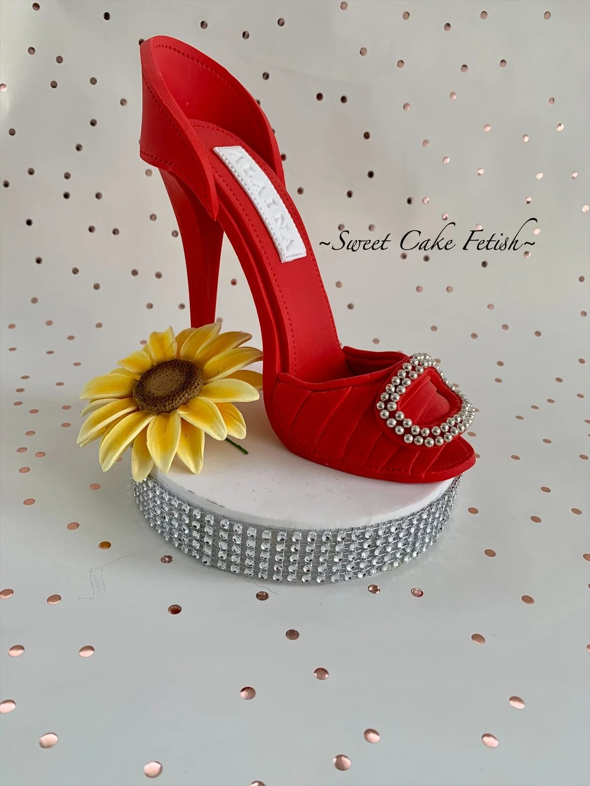 This is a handmade red high heel shoe made from gumpaste and non-edible silver pearls to be used as a cake topper. Good for any Birthday, Bridal and Wedding Custom Cakes at any Celebration