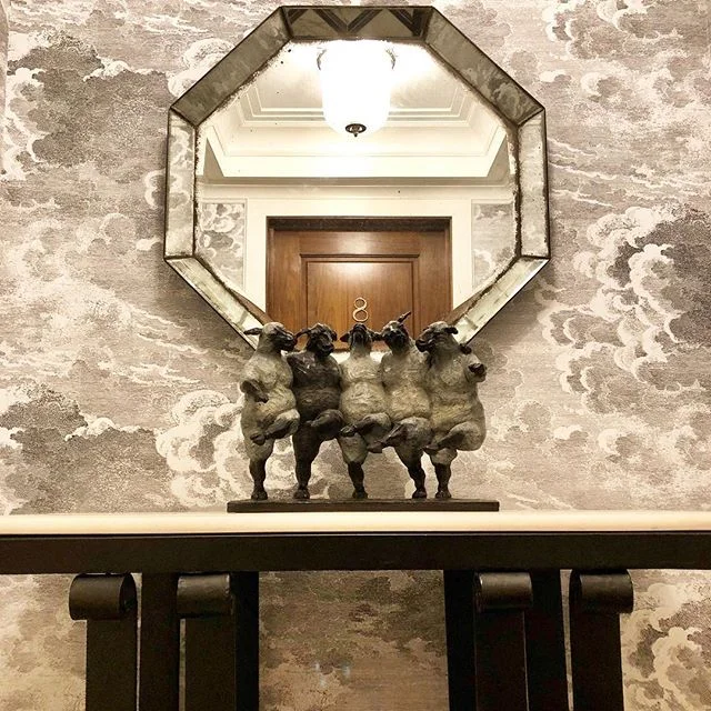 A statement-making entrance of my own design for this Monday... it all started with the fabulous Fornasetti wallpaper.  I love that it creates the illusion of depth in a small space.  The whimsical Giuseppi Palumbo sculpture and walnut door add warmt