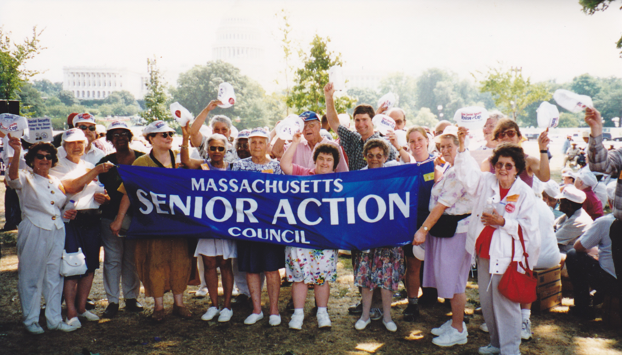 Group of people holding Massachusetts Senior Action Banner