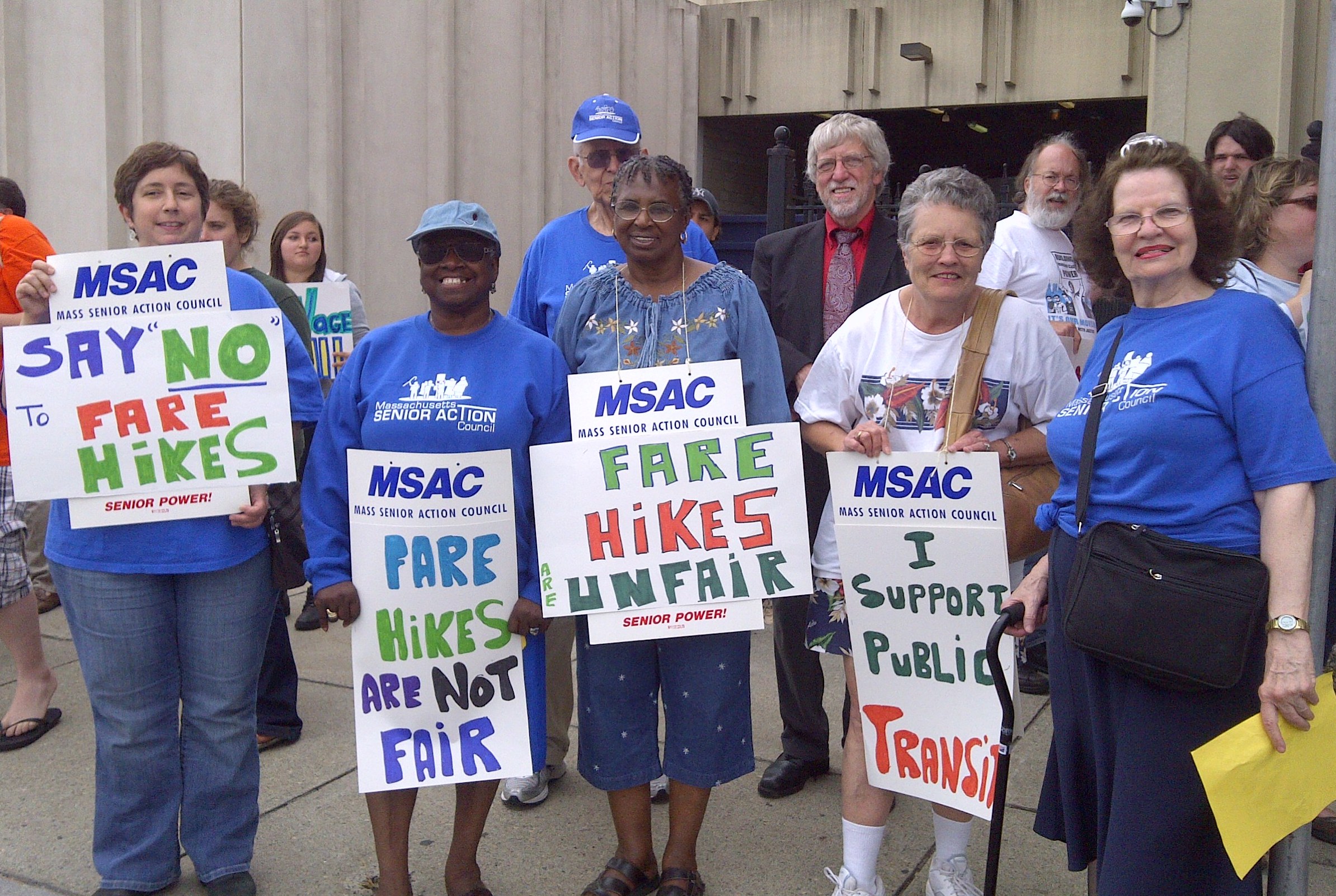 MSAC members holding signs reading say no to fare hikes