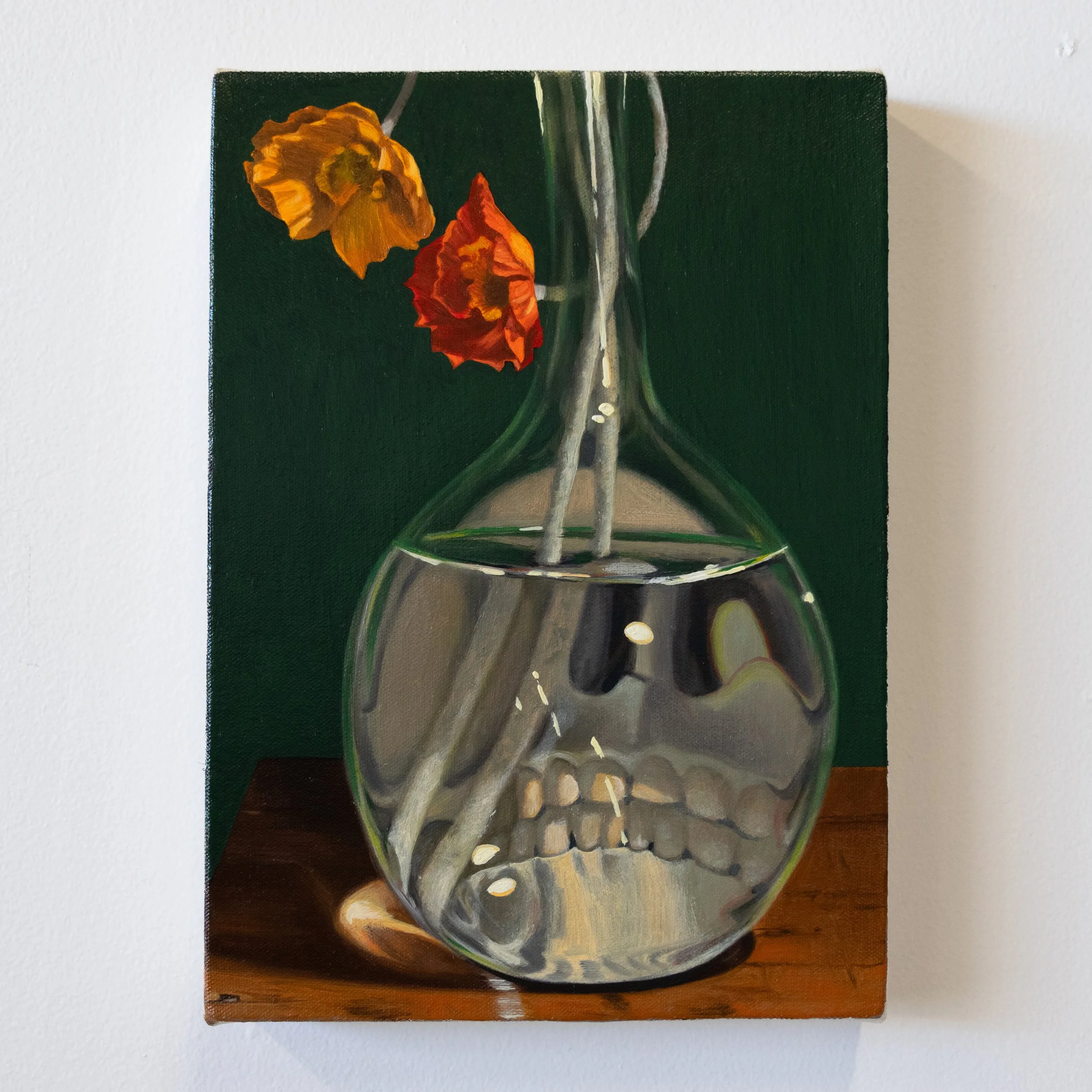 flowers in a glass vase with skull