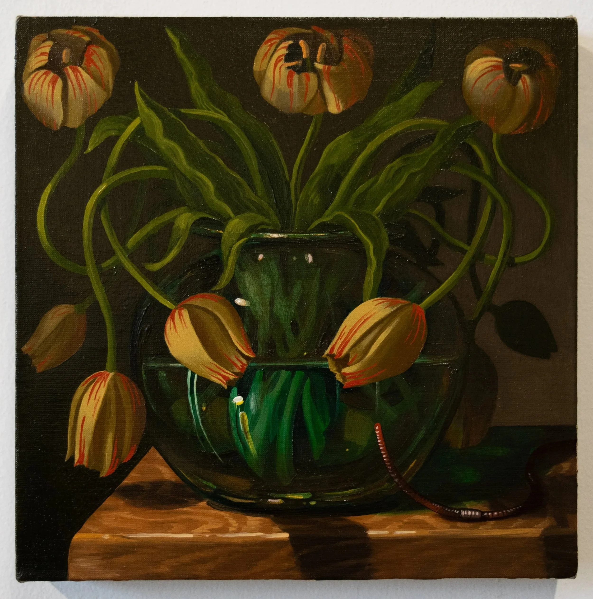 tulips in a green glass vase