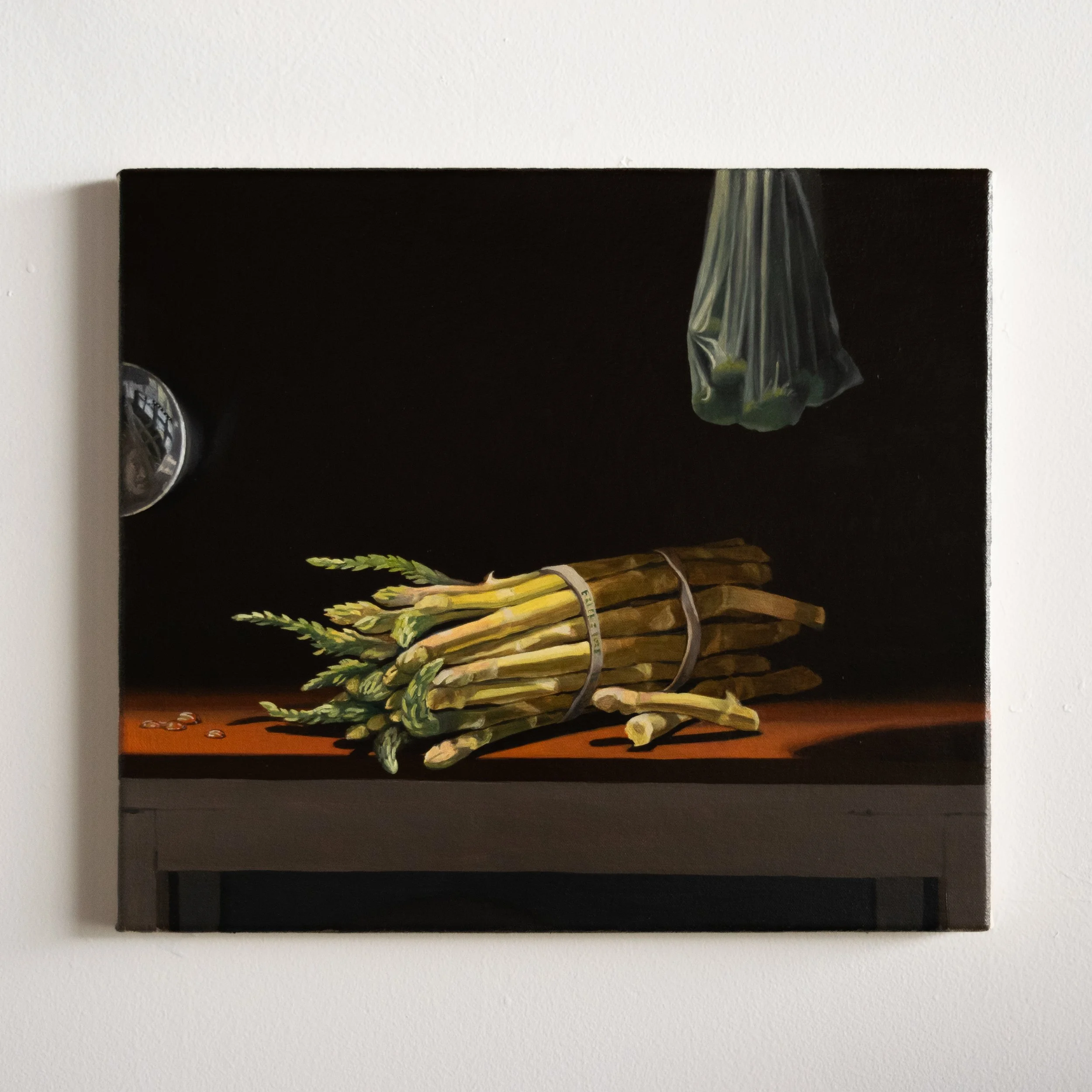 still life with white asparagus, grapes, and lens 