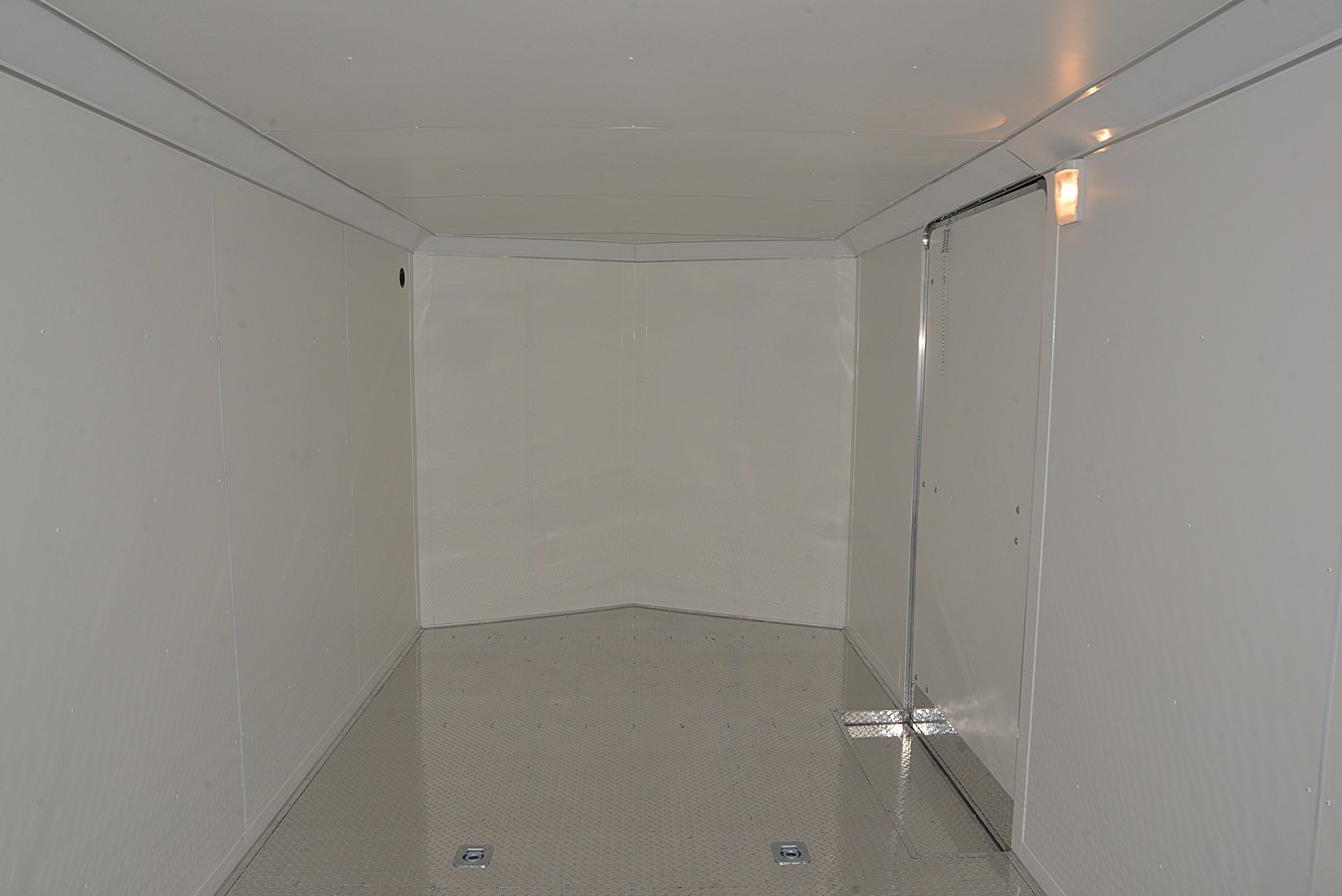 WHITE VINYL WALLS AND CEILING ALUMINUM TREAD-PLATE FLOORING