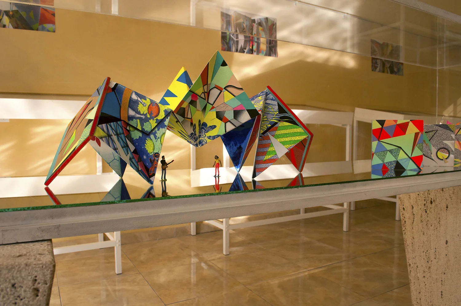 Praiadise Origami Accordion Book Sculpture - Gallery installation view on mirrored vitrine from Agora: Fantasia (Part I) solo exhibition with iSolAIR, Cape Verde Islands (West Africa)