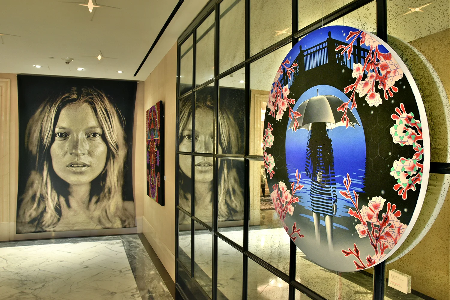 Peter D. Gerakaris' MoonGate Nocturne Tondo I (right) from Umbrella Girl Series , Installation view from Fashioning Art Group Exhibition at The Surrey Hotel in NYC. Also pictured: Chuck Close's Kate Moss tapestry from permanent collection (left) & Evie Falci's Kybele (center) in Fashioning Art.