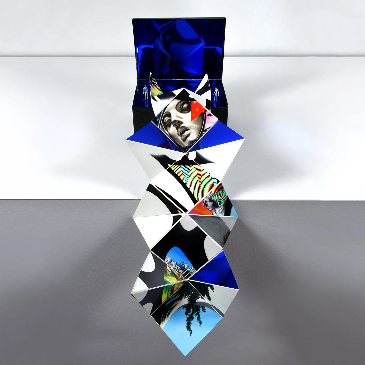 Pandora’s Box (frontal view) — Origami Sculpture for Mykonos Biennale 2019, (Apathia). Gouache, acrylic, mirrored mylar, & paper on yupo w/ painted figurines in mirrored box. Approximately 26 in x 8 in x 6 in (66.04 cm x 20.32 cm x 15.24 cm). 2019. Exhibited as part of Antidote Treasure Hunt on Dilos Island.